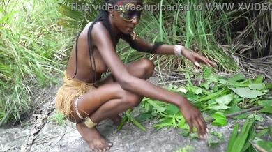 Hot African native woman cooking in the jungle